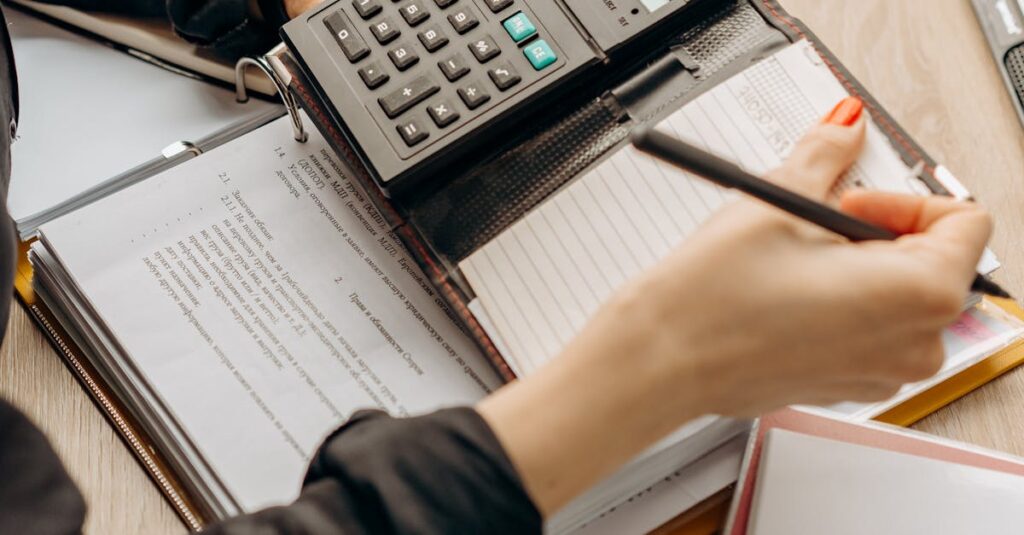 Hands using a calculator during paperwork in an office setting. Ideal for business concept visuals.